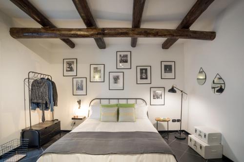 a bedroom with a bed and framed pictures on the wall at Futura Retrò in Salerno