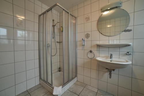 a bathroom with a shower and a sink at Landhaus Großes Meer in Südbrookmerland