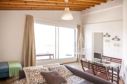 a living room with a couch and a table at Água de Alto Terrace House in Água de Alto