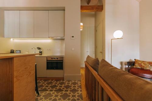a kitchen and living room with a couch in a room at Torel 1884 Suites & Apartments in Porto