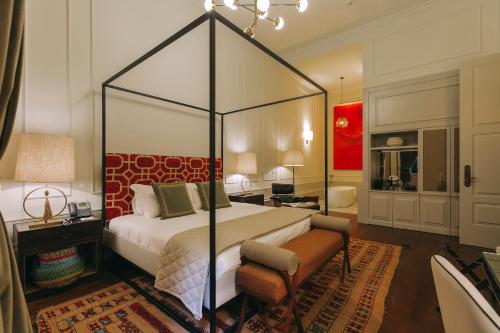a bedroom with a canopy bed in a room at Torel 1884 Suites & Apartments in Porto