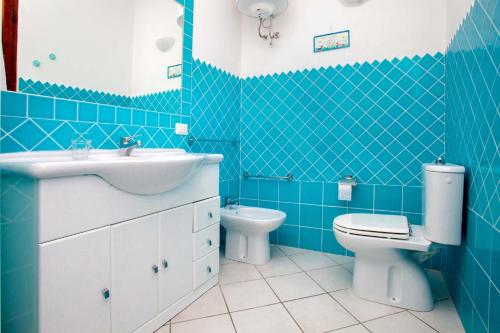 Quadrilocale Laura في سانتا تيريزا غالّورا: حمام أزرق مع حوض ومرحاض