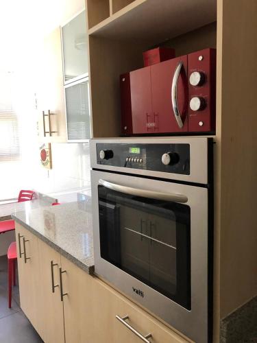 a kitchen with a stove with a box on top of it at Departamento en Viña del Mar in Viña del Mar