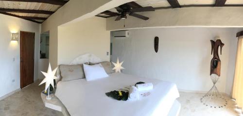 a bedroom with a white bed with stars on the wall at Cabrera Chalet boutique hotel in Cabrera