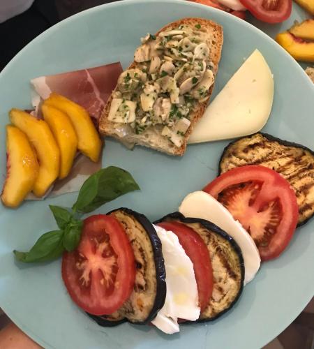 a plate of food with bread and tomatoes and cheese at Agriturismo Podere Rondinaio in Lamporecchio