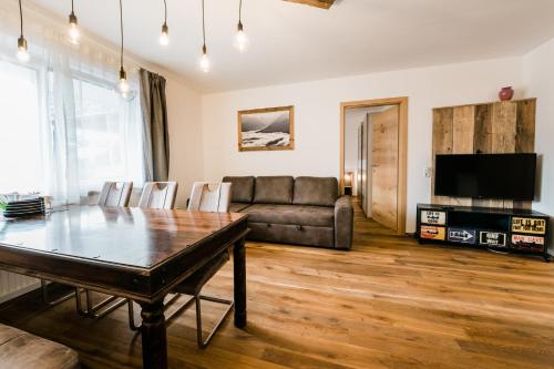 a living room with a couch and a table at Appartment Sorgenfrei in Altenmarkt im Pongau