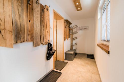 a hallway with a door and wooden cabinets at Appartment Sorgenfrei in Altenmarkt im Pongau