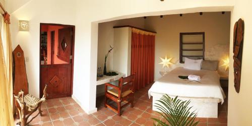a bedroom with a bed and a desk in a room at Cabrera Chalet boutique hotel in Cabrera