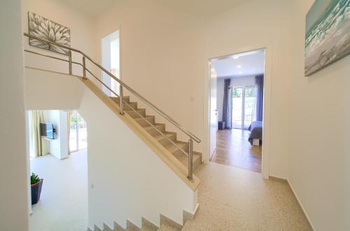 a staircase in a home with white walls at Villa St. Martin-Reef in Martinšćica
