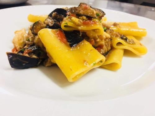 a plate of food with pasta on a white plate at Casa Fasano Amalfi Coast in Vietri sul Mare