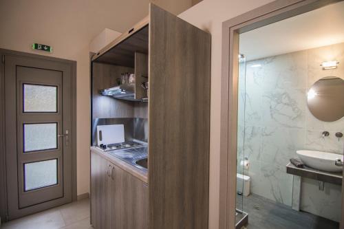 a bathroom with a sink and a toilet and a shower at Elia Luxury Apartments in Stavros