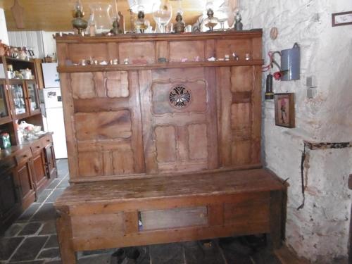 a large wooden cabinet in the corner of a room at Tyrbourg in Lopérec