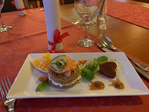 a white plate with food on a table at Titanic in Białystok