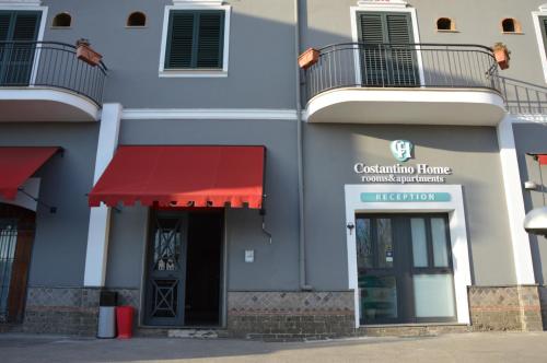 a building with a red awning in front of it at Costantino Home in Pompei