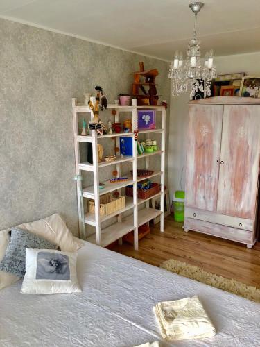 a bedroom with a bed and a dresser at Wind Rose apartment in Kuressaare