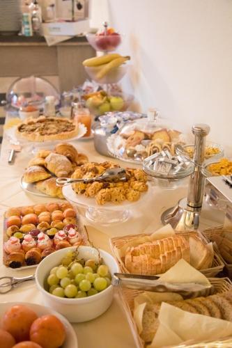 a table topped with lots of different types of food at Il Cortiletto Hotel Maison in Tresnuraghes