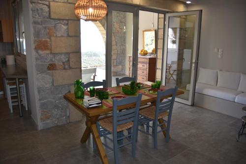 a kitchen and dining room with a wooden table and chairs at Athina's Stone House in Kardamyli in Kardamili