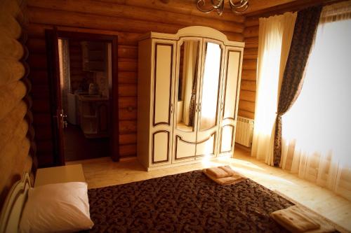 a bedroom with a bed and a large window at Oasis Karpat in Polyana