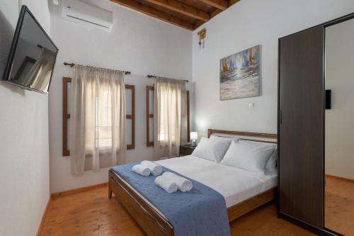 a bedroom with a bed with two towels on it at RUSTIC SELF-INN in Rhodes Town