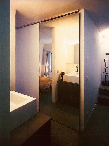 a bathroom with a tub and a sink and a mirror at BLoft Charme&Relax in Bergamo