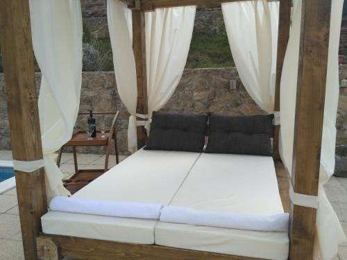 a bed in a porch with white curtains at HIDDEN PARADISE - Villa by Split in Žrnovnica