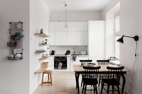 a kitchen with a table and chairs in a room at Urban Trendy Nordic Living in Helsinki