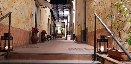 an alley way with vases and flowers in a building at Art & Jazz Hotel in Catania