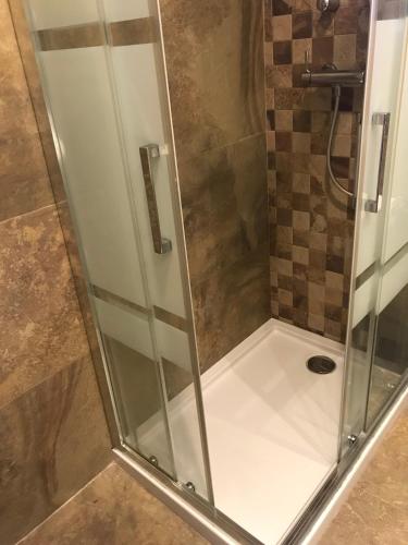 a shower with a glass door in a bathroom at Fercamar Costacabana in Almería