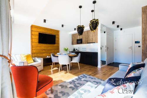 a living room with a couch and a table at Rezydencja Zakopiańska in Zakopane