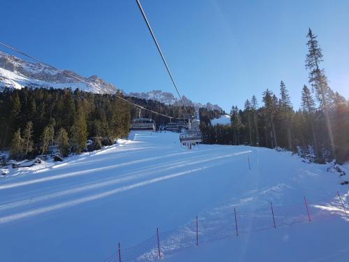 a snow covered ski slope with a ski lift at Obereggen - Anna in Eggen