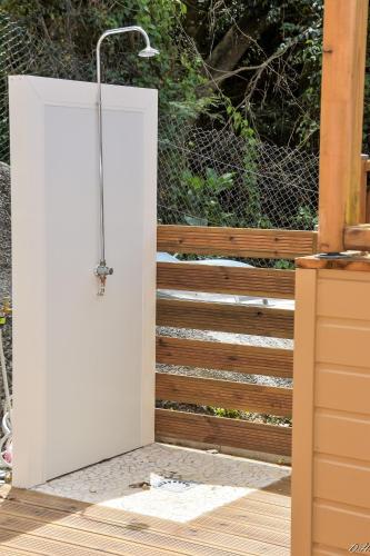 a white door leading to a deck with a fence at Villa Nord-Plage in Les Anses-dʼArlets