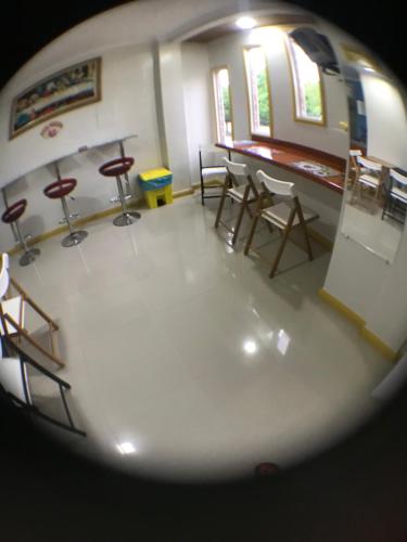 a view of a room with chairs and tables at Hotel Pousada LG in Breves