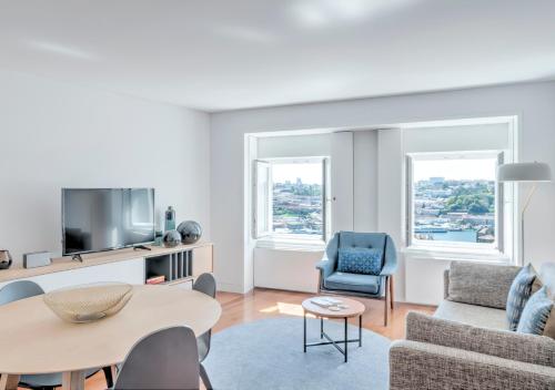 a living room with a couch and a table at Oporto Street das Aldas - River View in Porto