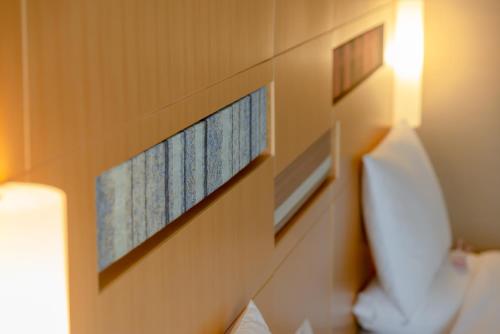 a bedroom with two pictures on the wall next to a bed at Hotel Okura Fukuoka in Fukuoka