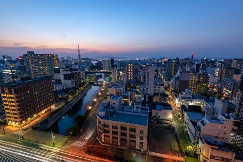 a view of a city at night with traffic at Hotel Okura Fukuoka in Fukuoka