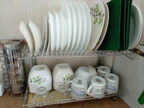 a shelf with plates and cups and dishes on it at Lot 4 PD Villa in Port Dickson