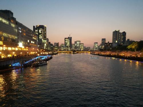 a view of a river with a city at night at Hotel Osaka Castle in Osaka