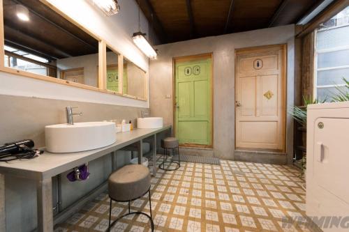 baño con lavabo, encimera y puerta en 158 Hostel en Tainan