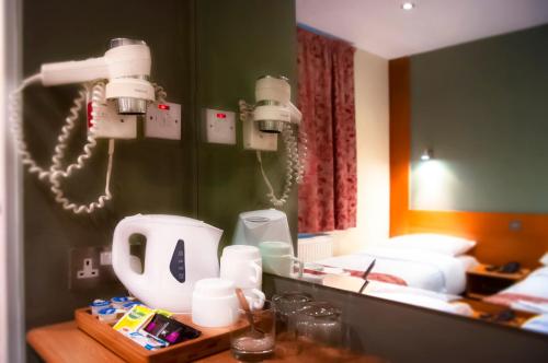 a room with a bed and a table with lights at Westbury Hotel in London