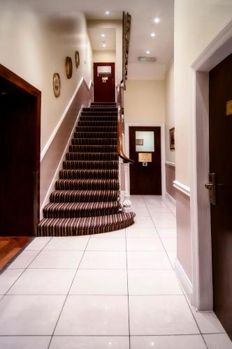 a staircase in a building with a tile floor at Westbury Hotel in London