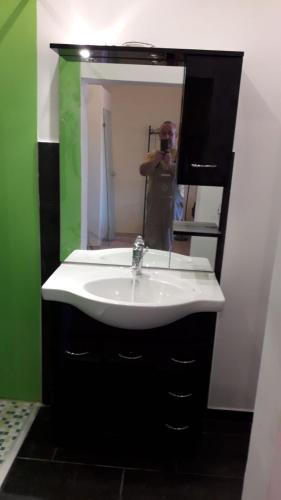 a bathroom with a white sink and a mirror at Doppelbettzimmer mit Bad in Kaiserslautern