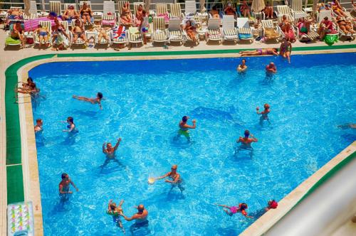 a group of people swimming in a swimming pool at Club Shark Hotel in Gümbet