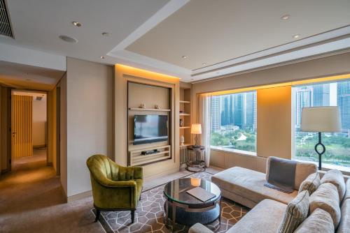 a living room with a couch and a tv at IFC Residence in Shanghai