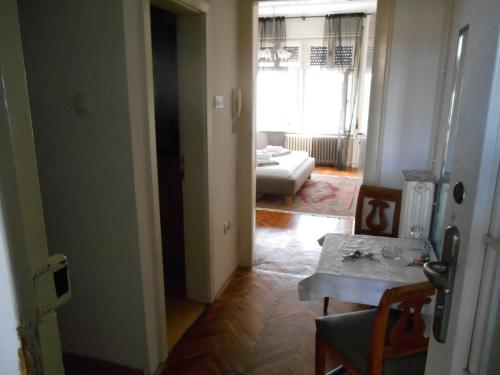 a hallway with a room with a table and a living room at Dunavski Park in Novi Sad