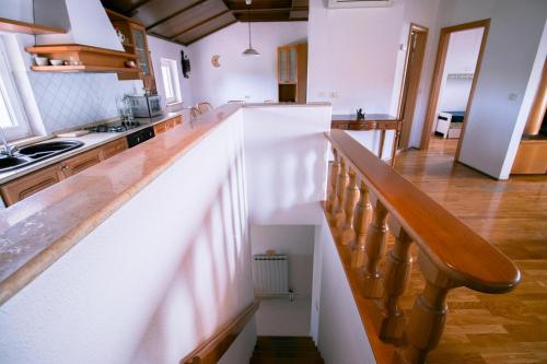 a kitchen with a staircase leading up to a kitchen at Apartments Apartim Piran in Piran