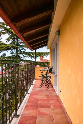 a patio with a table and chairs on a balcony at Apartments Apartim Piran in Piran