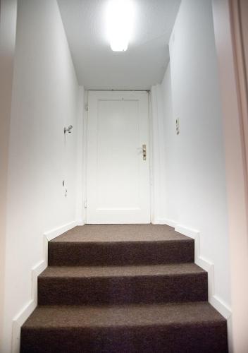 a staircase in a building with a white door at Looks Inn in Heidelberg