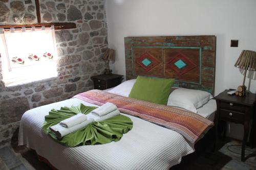 a bedroom with a bed with towels on it at TAŞKONAK in Bergama