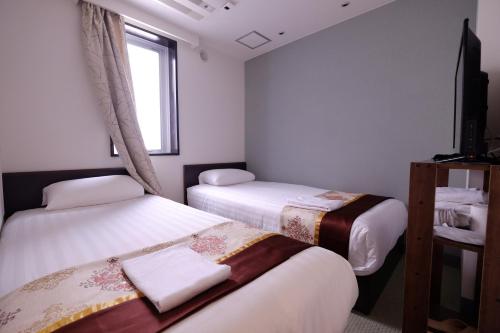 Ένα ή περισσότερα κρεβάτια σε δωμάτιο στο Tabata Oji Hotel