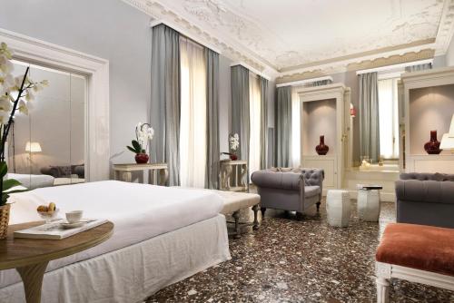 a bedroom with a bed and a table and chairs at Al Palazzo del Marchese di Camugliano Residenza d'Epoca in Florence
